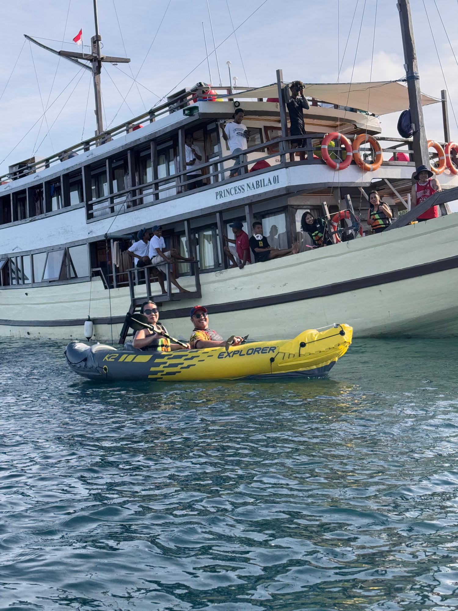 Inflatable kayak with two guests beside Princess Nabila