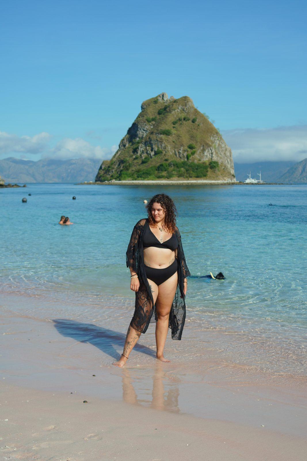 Kelor – woman in black cover-up on sand, islet (Taken on a real Komodo Explorer trip)