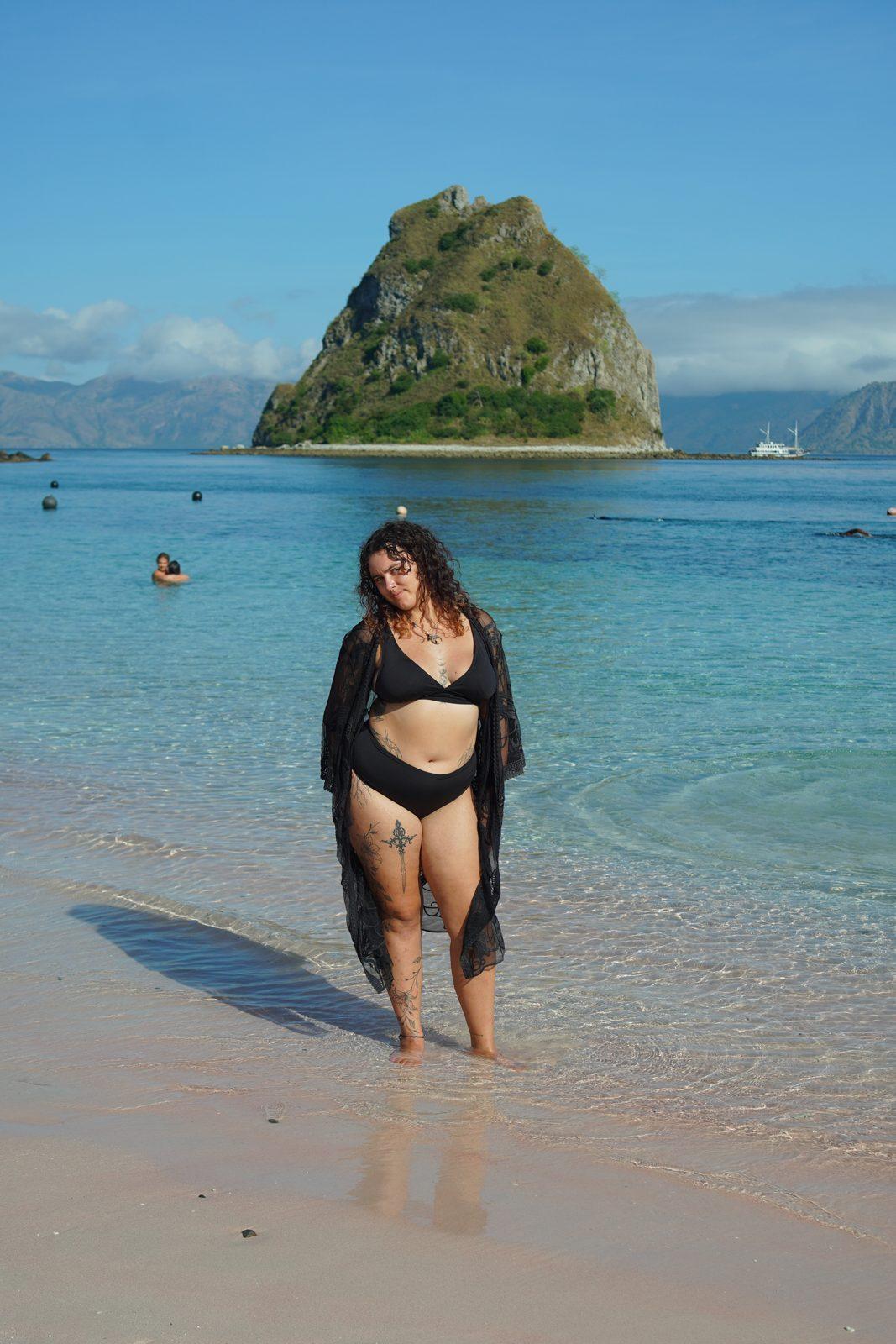 Kelor – woman walking in shallows, islet behind (Taken on a real Komodo Explorer trip)