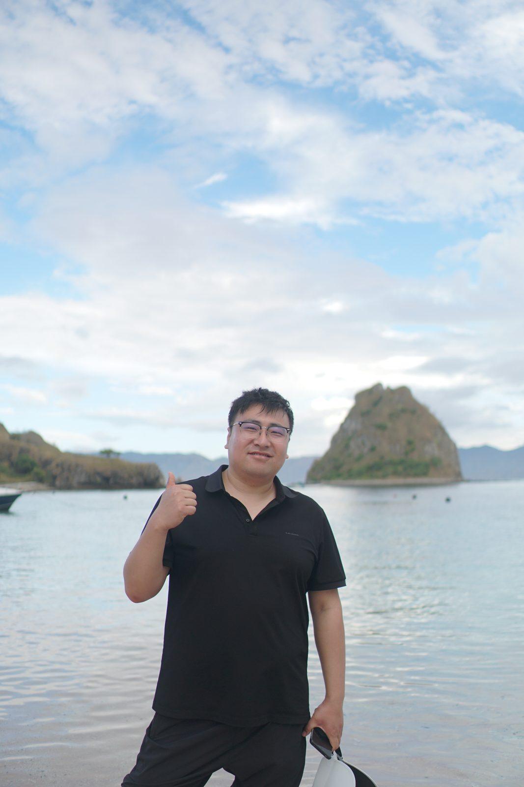 Kelor – man on shore, islet behind (Taken on a real Komodo Explorer trip)