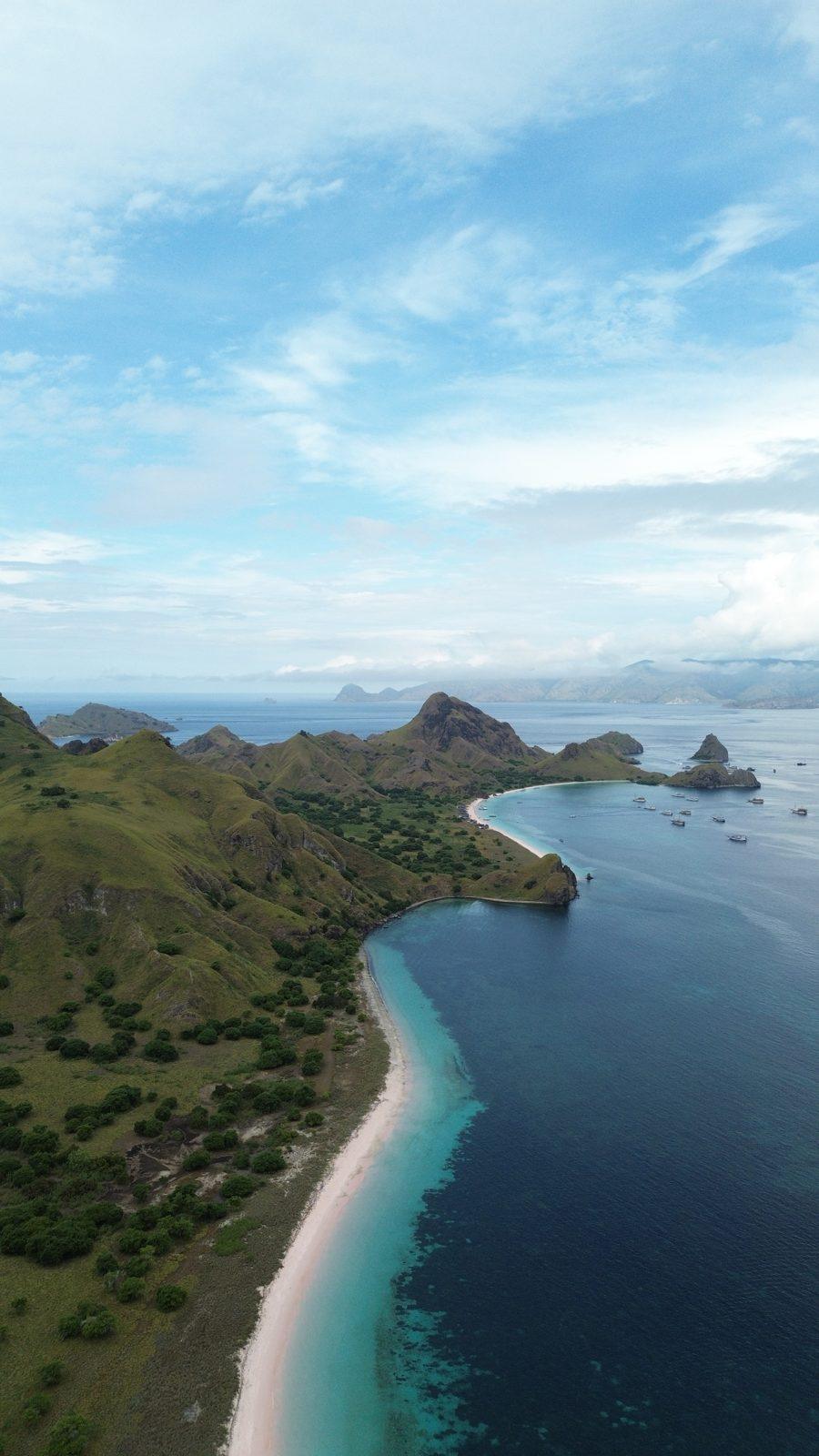 Padar – Aerial green headland, curved white beach (Taken on a real Komodo Explorer trip)