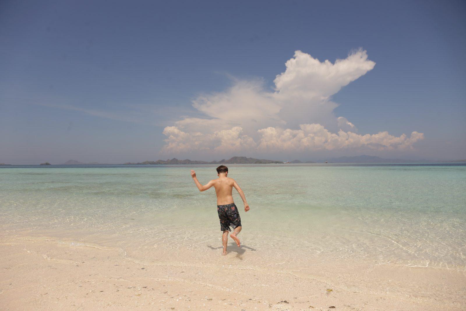 Taka Makassar – man walking on sandbar, cloud behind (Taken on a real Komodo Explorer trip)